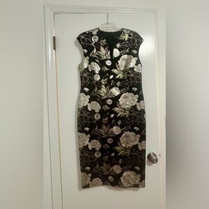 New with tags- stunning dress Size 14. Gorgeous floral design with some shimmer.
